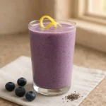 Psychobiotic Smoothie Recipe: Gut-Loving Morning Fuel 7 berberine smoothie in a clear glass with lemon zest and berries